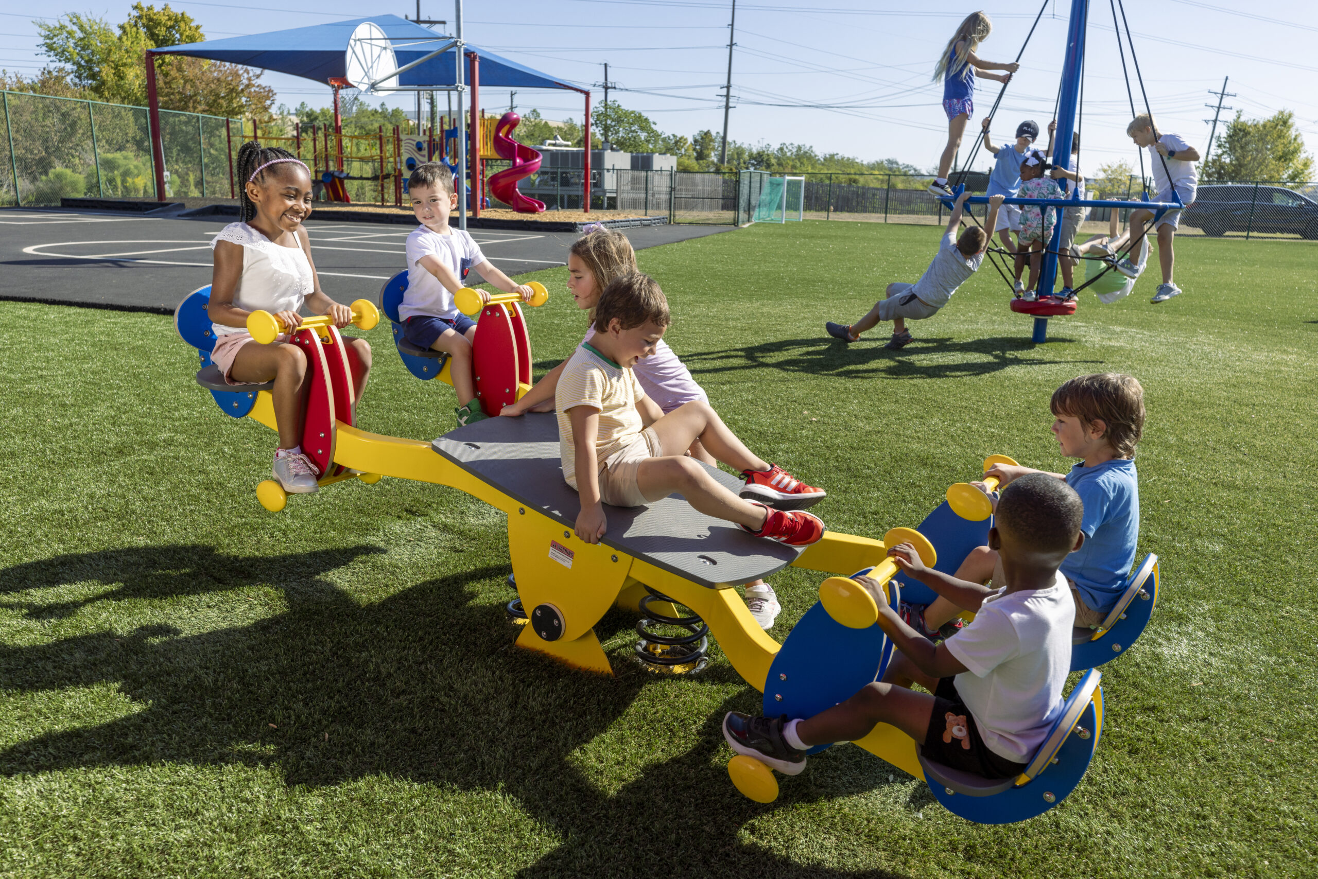 Kids playing on an inclusive seesaw
