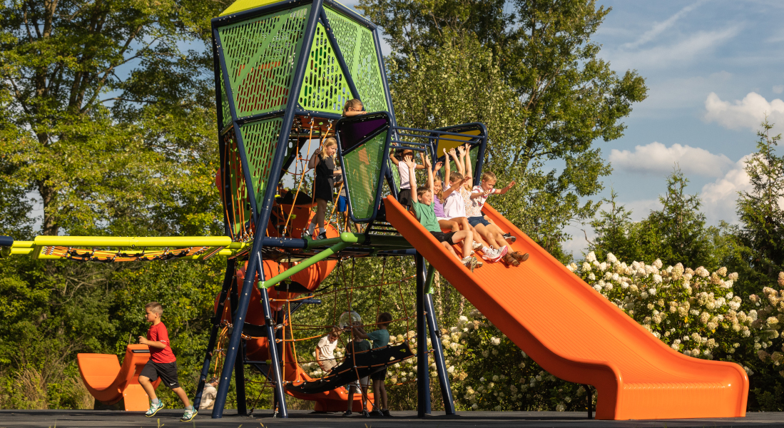 Children sliding down the mighty decent slide connected to Playworld's Torres play equipment.